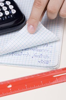 Student checking a problem in a math notebook.