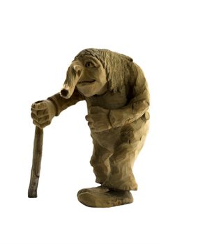 Old Troll with walking stick, carved from wood, on white background. Traditional Norwegian handicraft based on old fairytales