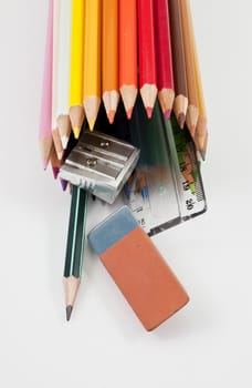 School supplies on a white background outgoing of colored pencils tube