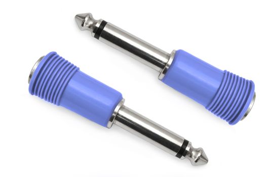 Close up capturing a two blue jack plug pins arranged over white