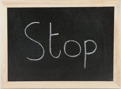 Black chalk board with wooden framed surround with the word Stop.