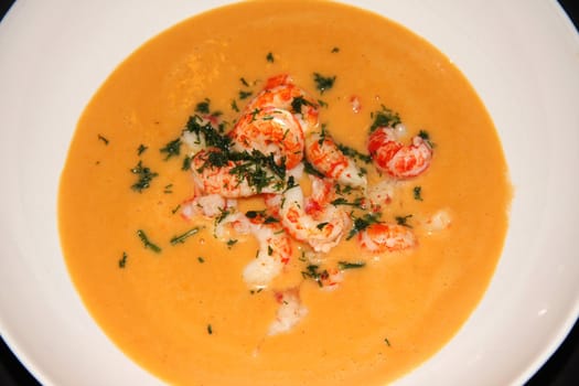 orange soup with seafood in.