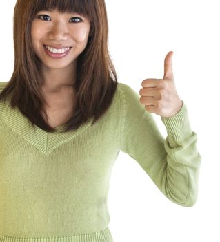 Young female giving thumbs up sign.