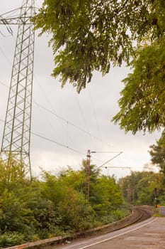 Platform at electrified railway track under high voltage power transmission line.