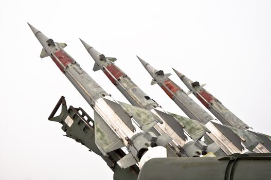 Several combat missiles aimed at the sky. Isolated on a white background. Missile weapons.