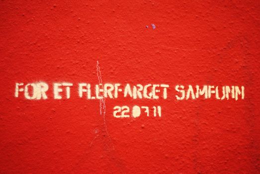 A norwegian stencil reading "For a multicoloured society" in commemoration of the victims of the terror attacks 22.07.2011.