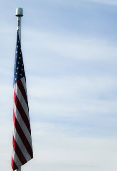 The Flag of the United States of America, hanging in a calm sky.