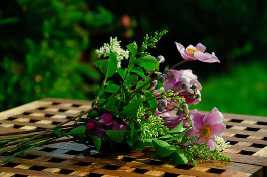 A bouquet of flowers lying on a garden table
