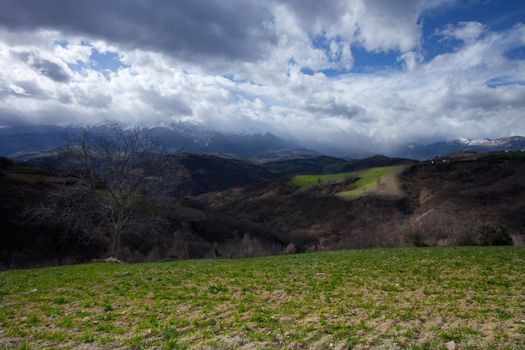 Rolling hills with cloud covered skies in Italy