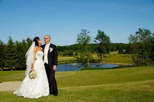 Wedding couple is looking at eachother.