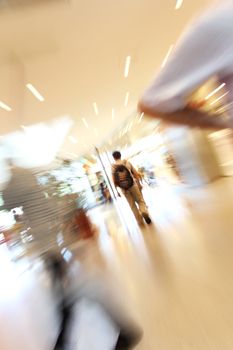 blurred unrecognizable people in motion in a shopping mall