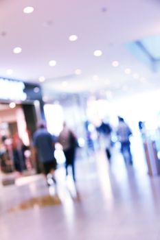 blurred unrecognizable people in motion in a shopping mall