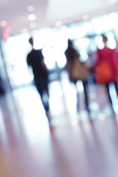 blurred unrecognizable people in motion in a shopping mall