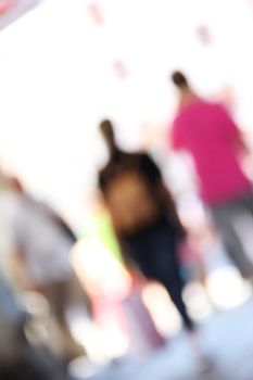 blurred unrecognizable people in motion in a shopping mall