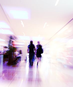 blurred unrecognizable people in motion in a shopping mall