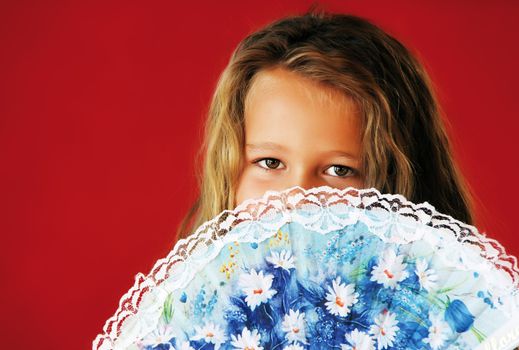 little girl with air fan in front of the face