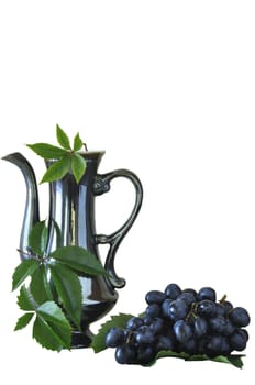 Grapes and old jug on the white isolated background
