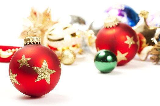 red dull christmas ball in front of colorful christmas ornaments