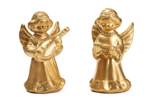 two golden christmas angel figurines as musicians on white background