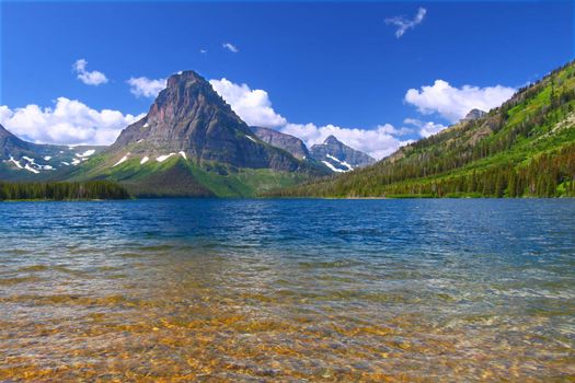 Mount Sinopah rises over Two Medicine Lake on a gorgeous summer day in Glacier National Park.