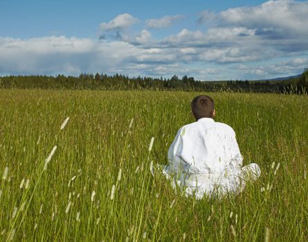 The person is engaged in meditation far away from civilization