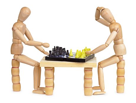 Two silly wooden little men play chess on white background