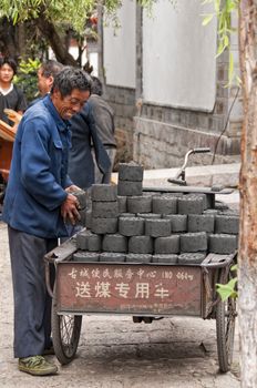 Unidentified Man delivering Coal in Lijiang, China, July 8 2010. The People's Republic of China is the largest consumer of coal in the world.