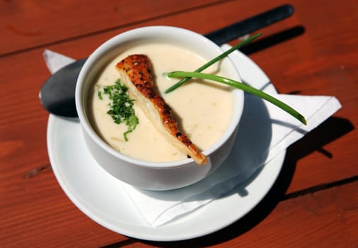 Traditional home made soup called Kyselica in bowl on wooden table from Walachia