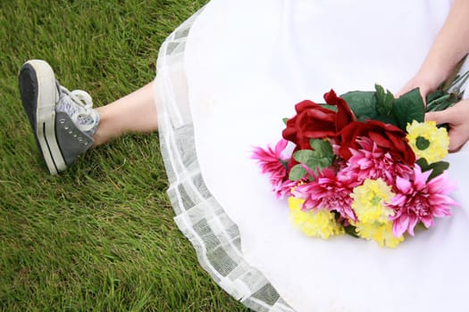 A bride wearing running shoes and a wedding gown