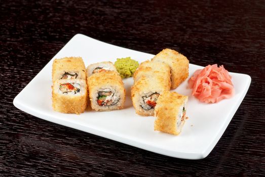 Sushi rolls made of rice, smoked eel, cream cheese and flying fish roe - tobiko caviar