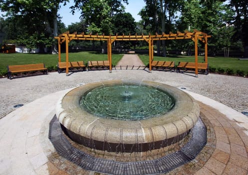 Garden with small fountain and benches around