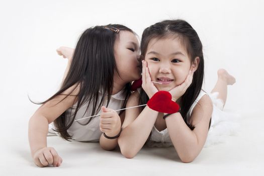 Little girl kissing her sister