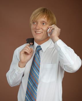 The young man talks by a mobile phone