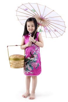 Little oriental girl in traditional Chinese dress cheongsam with umbrella and basket