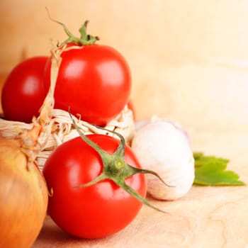 tomatoes and garlic in kitchen on wood with copyspace