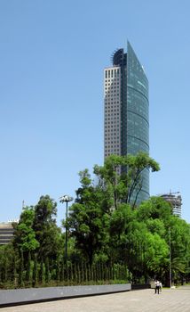 Skyscraper with green high trees around in Mexico city