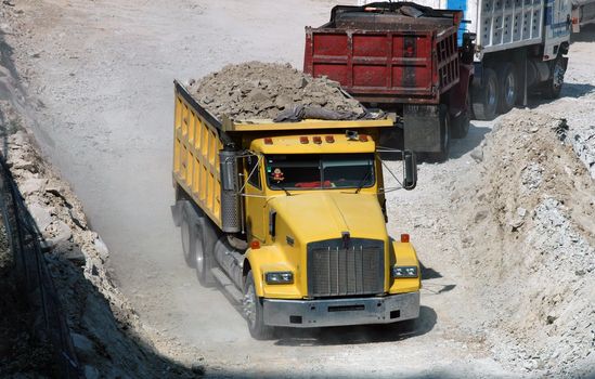 Red and yellow vans excavator on building ground in Mexico city