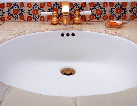 Detail of luxury sink with gold tap in hotel room
