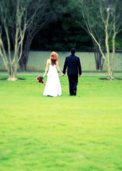 Bride and Groom walking away, cross process, intentional blur