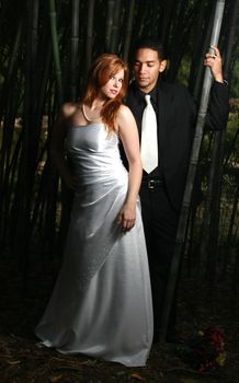 Sexy couple standing in a bamboo forest