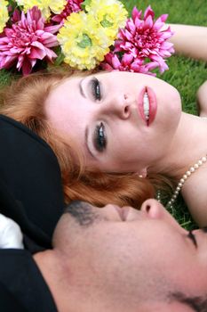 Bride and Groom lying in grass