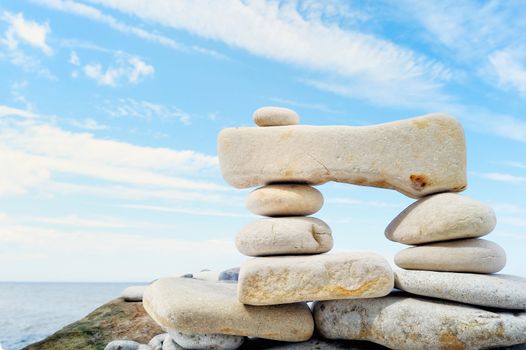 Small pebbles are connected with a large stone on seacoast