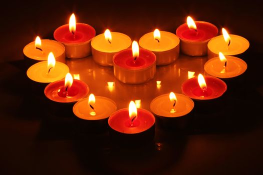 Fourteen lighting little candles in form of heart