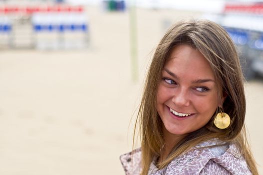 Cute attractive women smiling at the beach. Summer portrait. Blurring background.