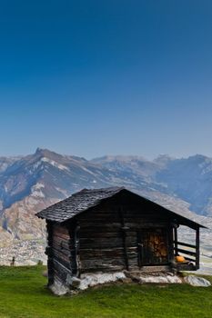 A hut with Swiss Alps as background