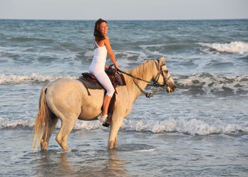 smiling riding young woman in the sea