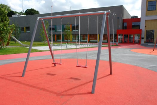 Modern design metal swing in a new city playground                              