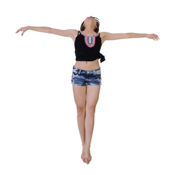 Young girl jumping and open arms, full length portrait isolated on white background.