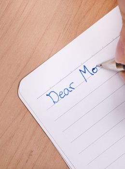 A letter writing to mom on white lined paper