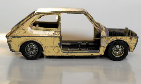 Old abandoned burned car isolated over white